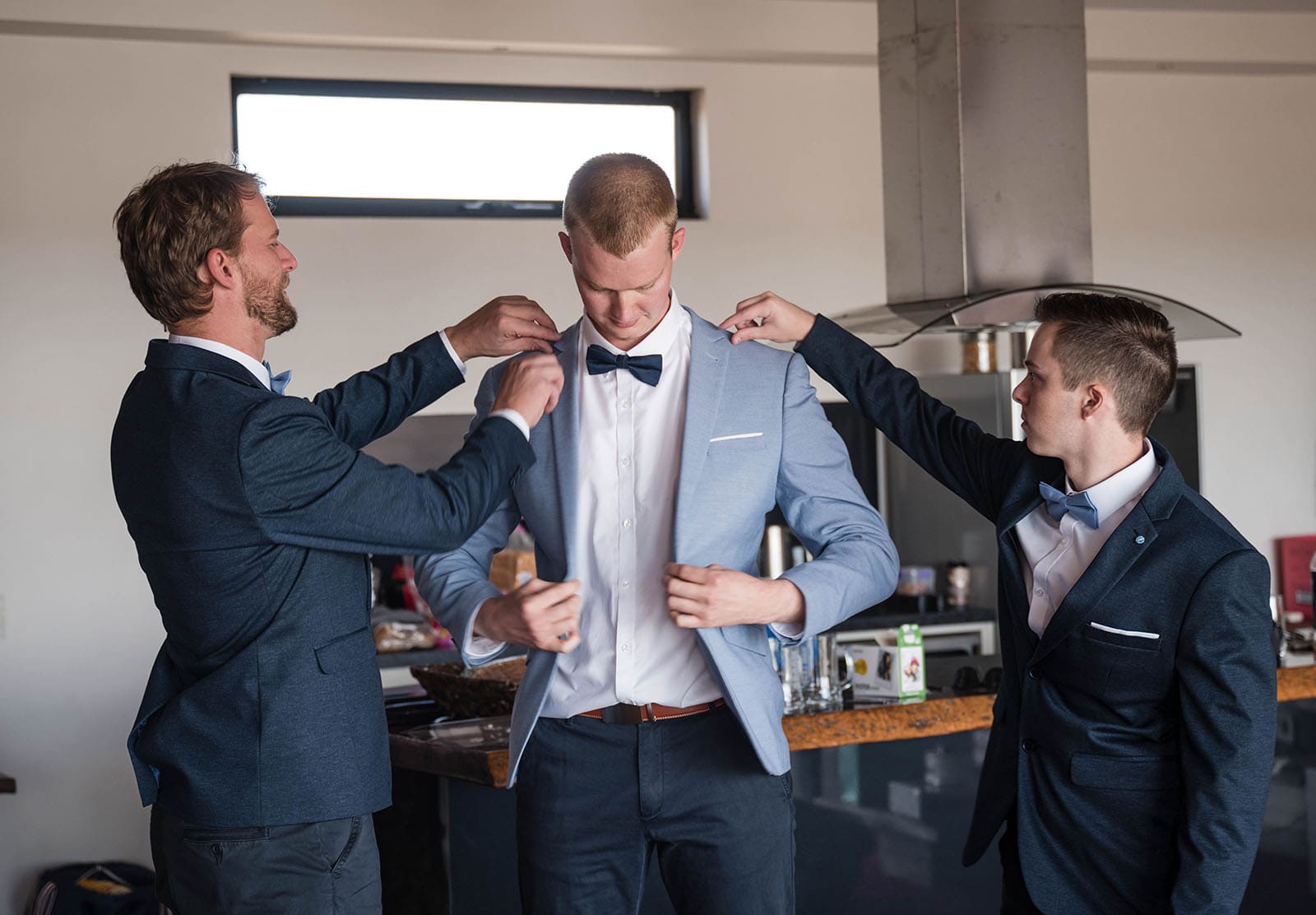riverland wine centre wedding - lisa & mitch 170 Groomsmen fussing over grooms jacket