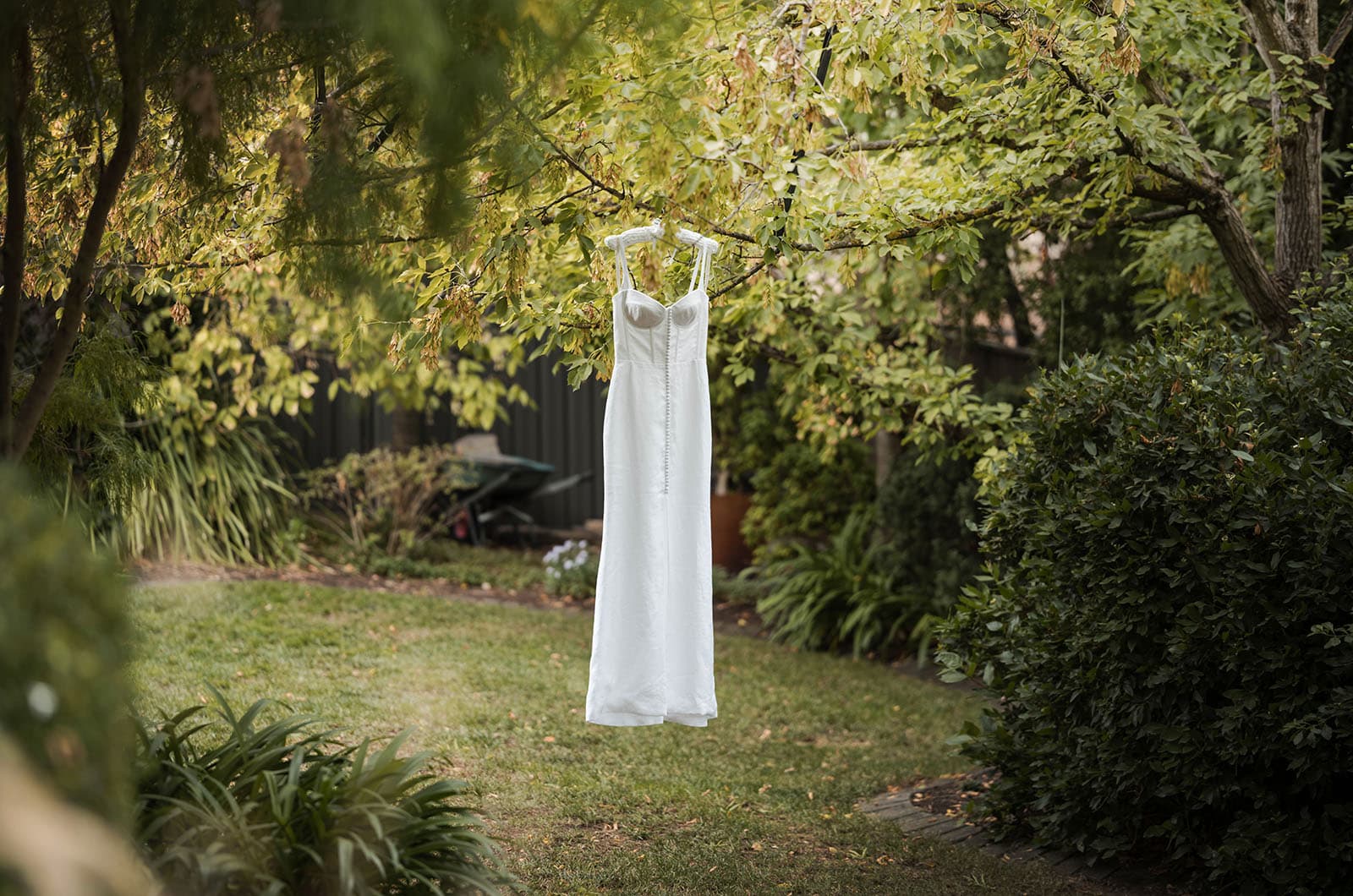 house on haines wedding - danieka & jack 29 Wedding dress hanging in green trees