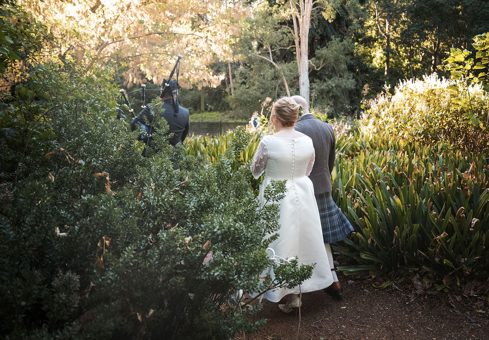 barbershop gazebo wedding, botanic gardens - helen & john 15 Bridal couple being led by bagpiper