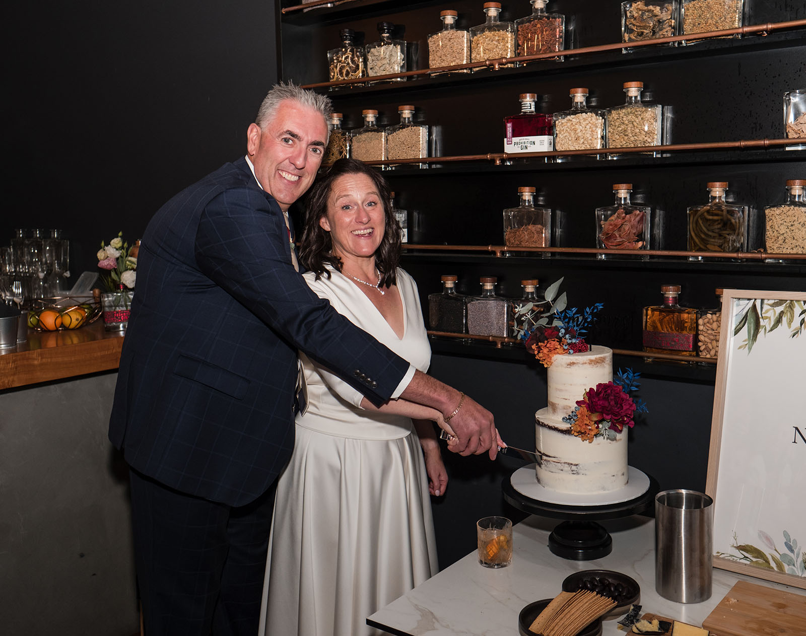 northern palm garden wedding - nicole & daryl 144 bridal couple cutting cake at Prohibition Liqour co