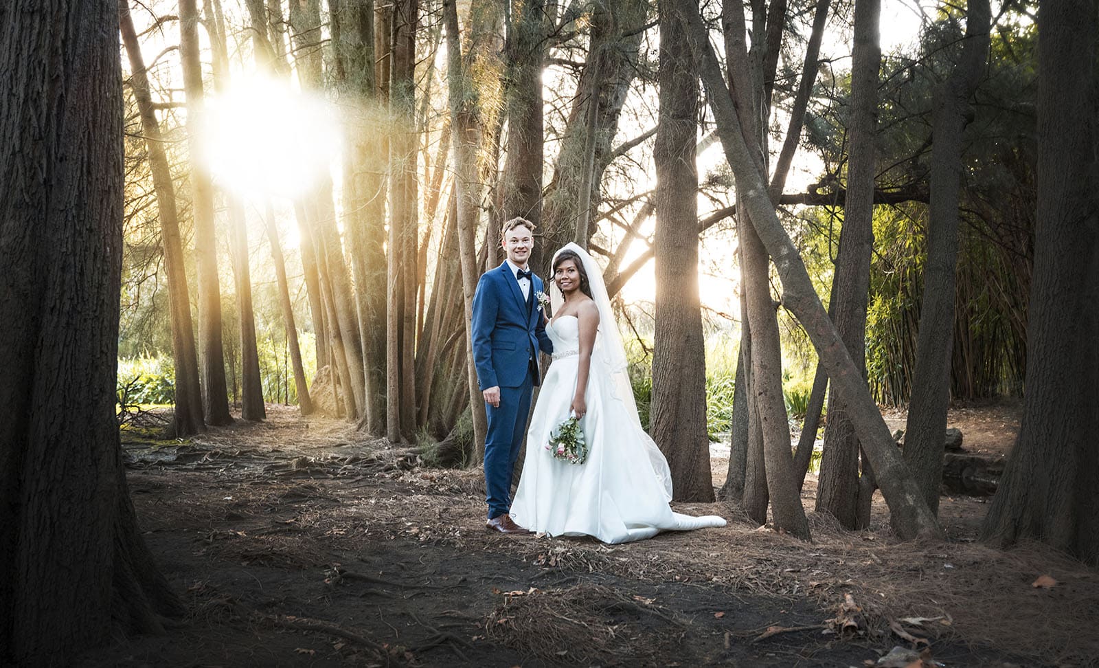 our lady of the rosary church wedding - lorraine & wayne 187 Bridal couple in forest with sunlight
