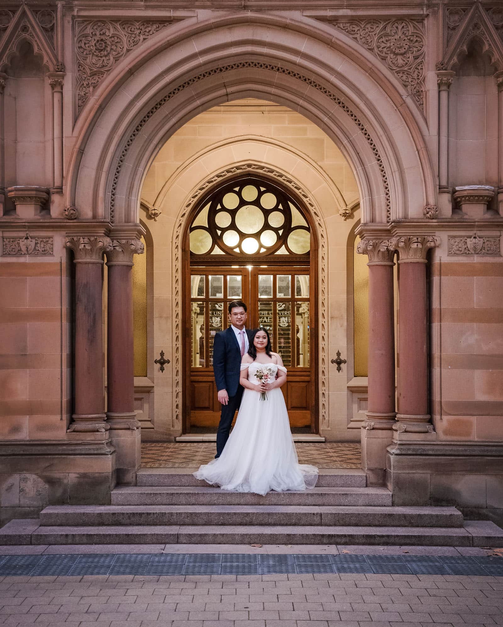 chesser st registration office wedding - khate & angelo 99 bridal couple under arch