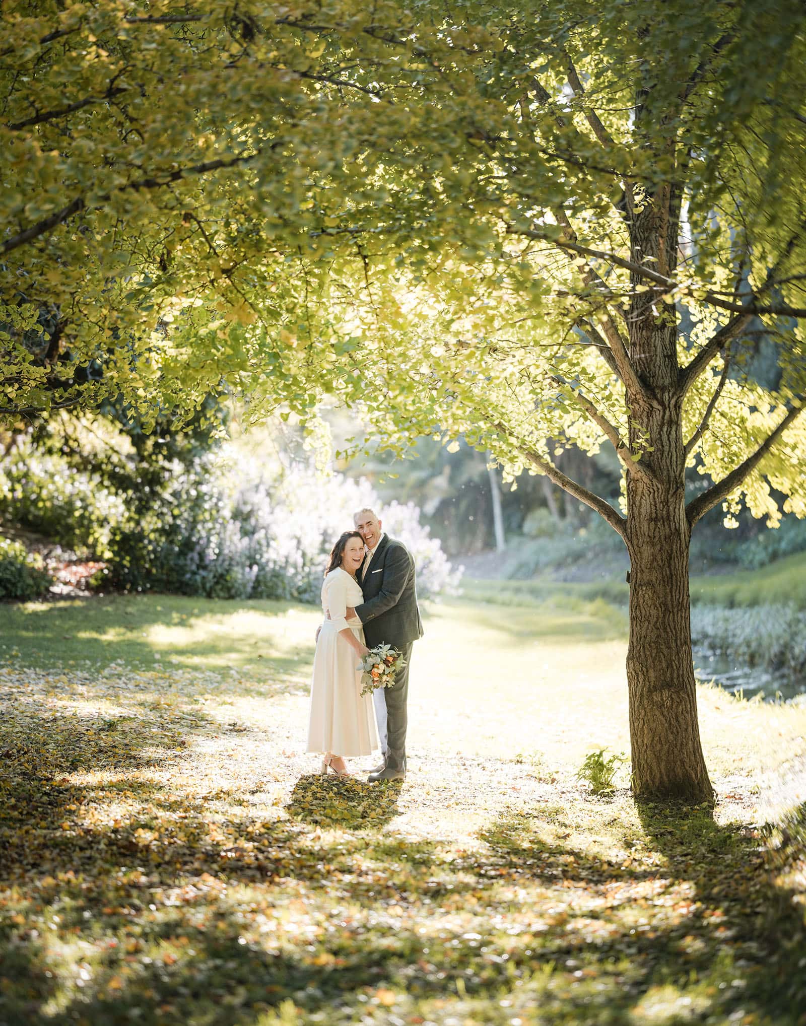 northern palm garden wedding - nicole & daryl 131 bride and groom backlit by bright sun