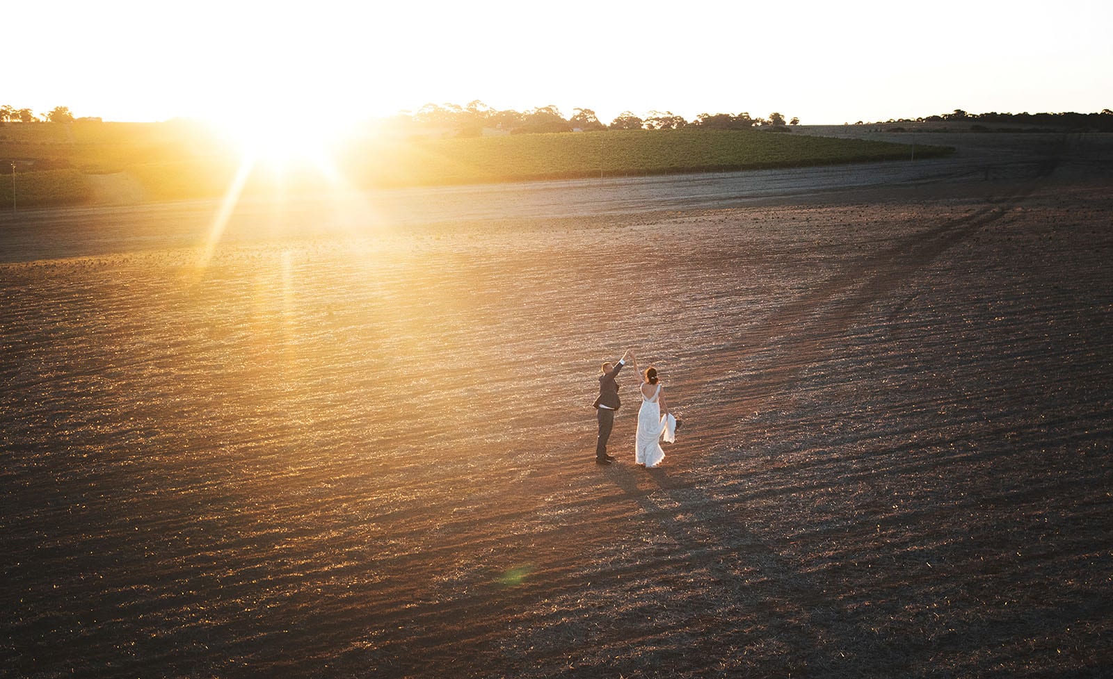 the beauty natural light vs studio light in photography 2 Bride and groom dancing in open field