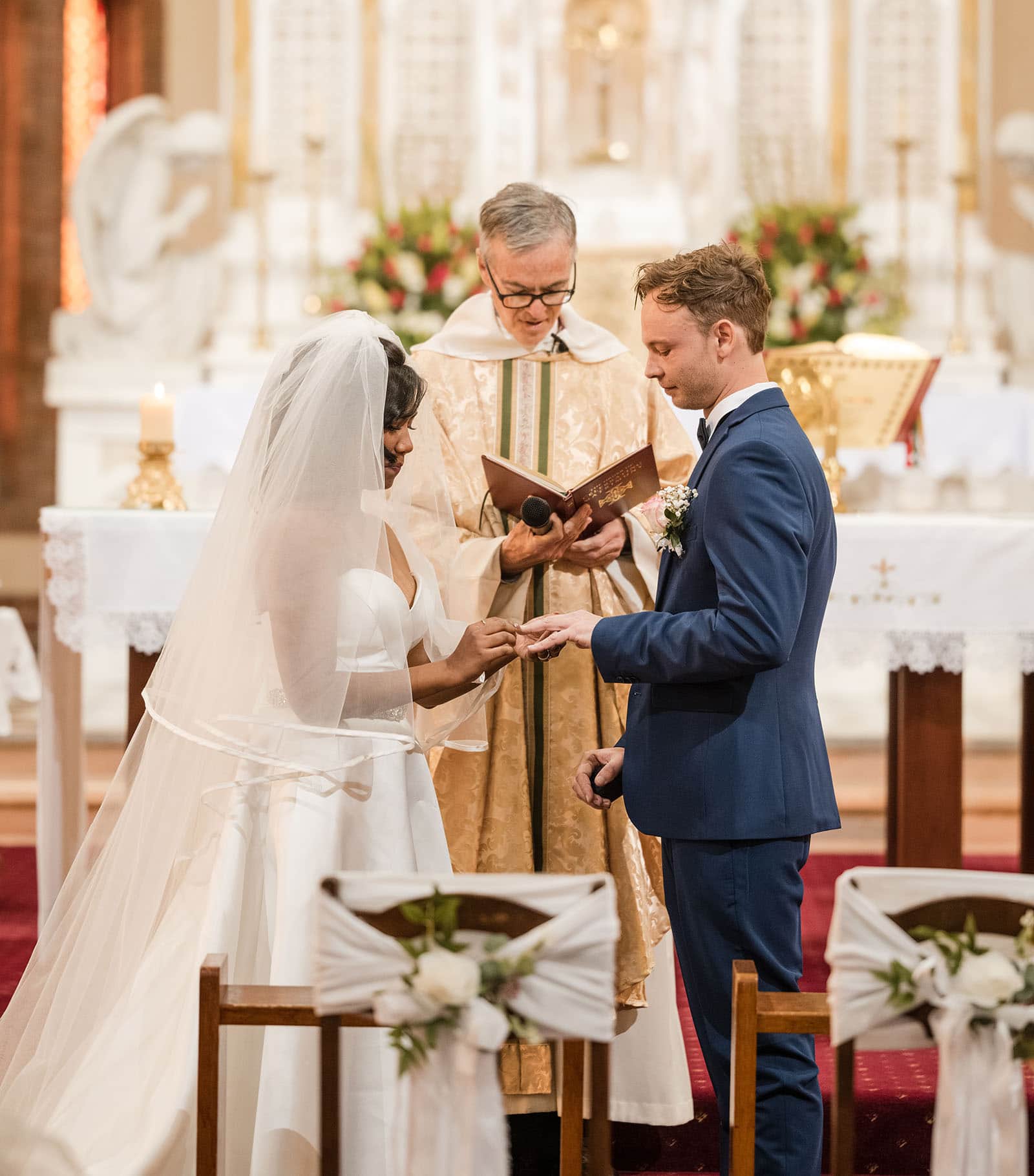 our lady of the rosary church wedding - lorraine & wayne 164 Bride and groom exchanging rings in church