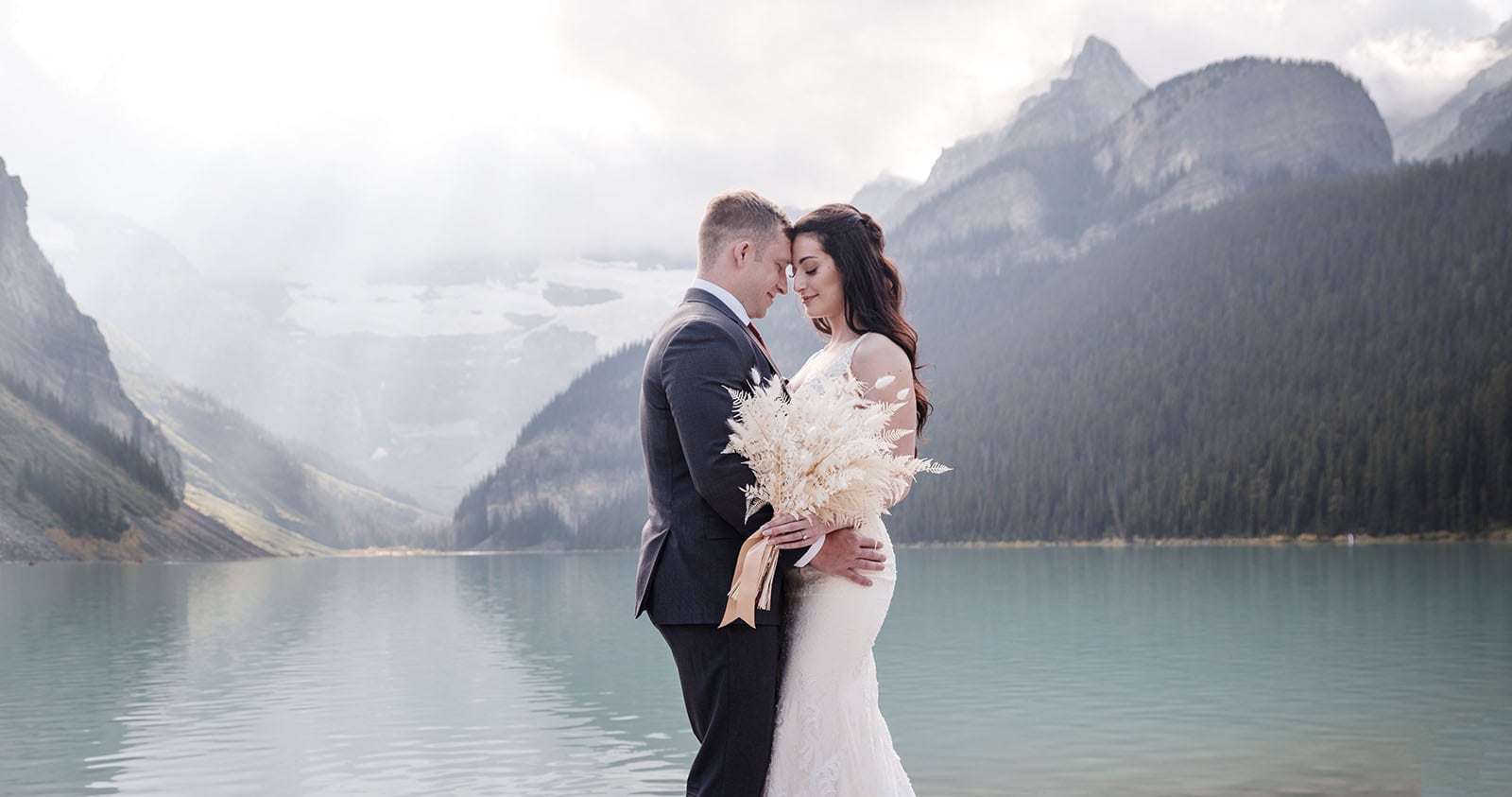 canada's lake louise wedding photoshoot - melodie & brandon 13 Bride and groom in front of Lake Louise