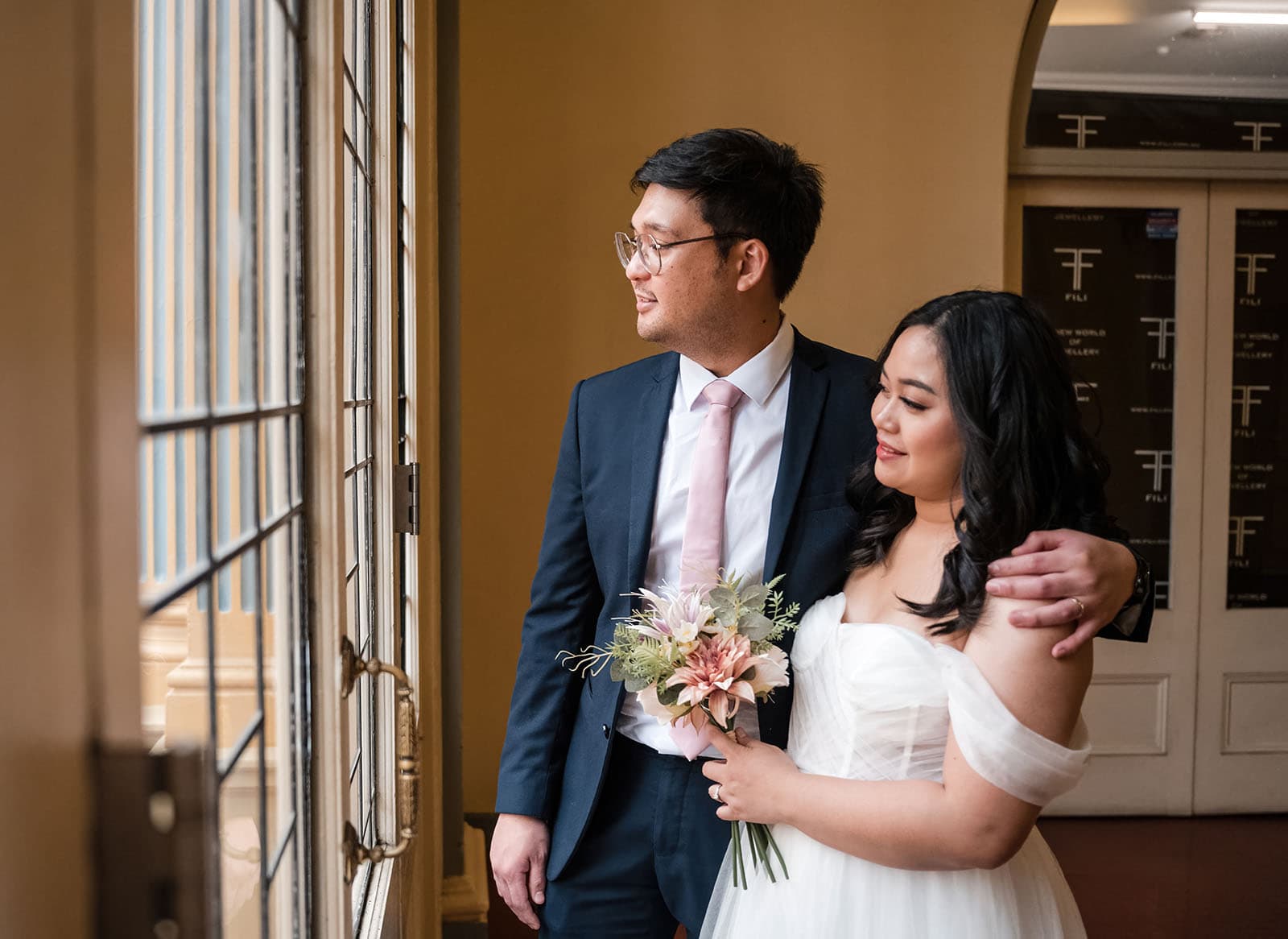 chesser st registration office wedding - khate & angelo 80 bride and groom looking out window together