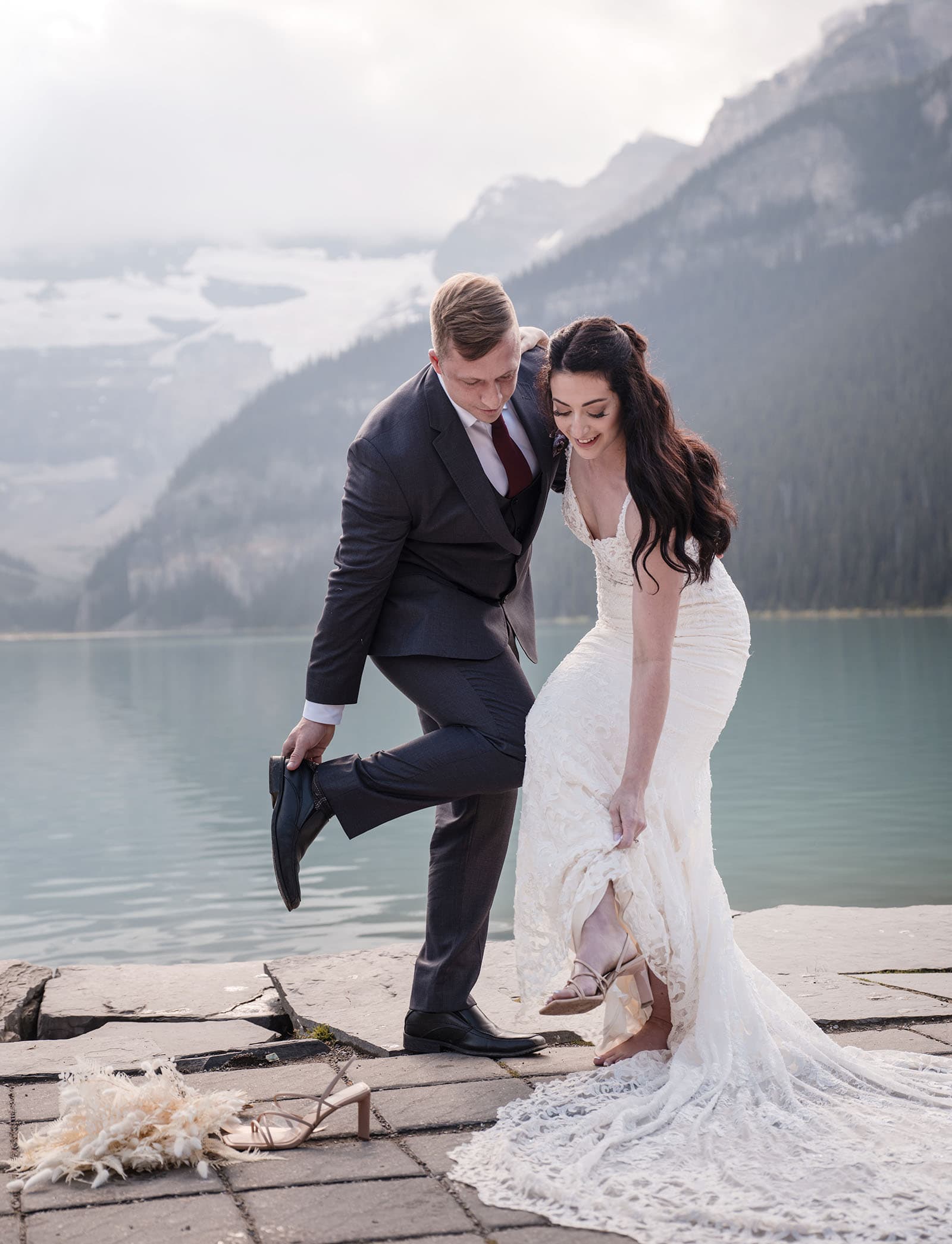 canada's lake louise wedding photoshoot - melodie & brandon 14 Bride and groom taking off shoes