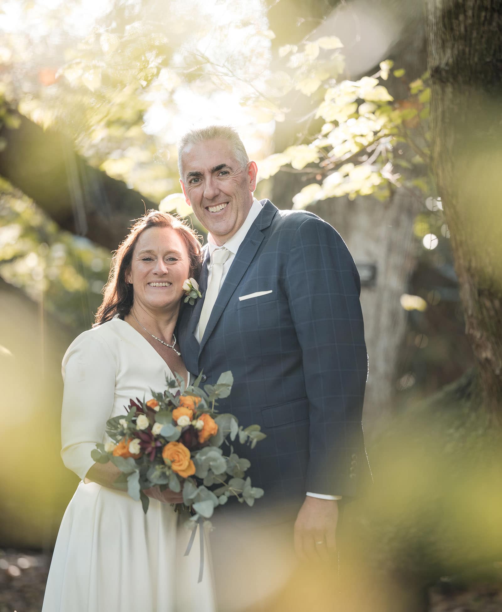 northern palm garden wedding - nicole & daryl 128 Bride and groom through foliage