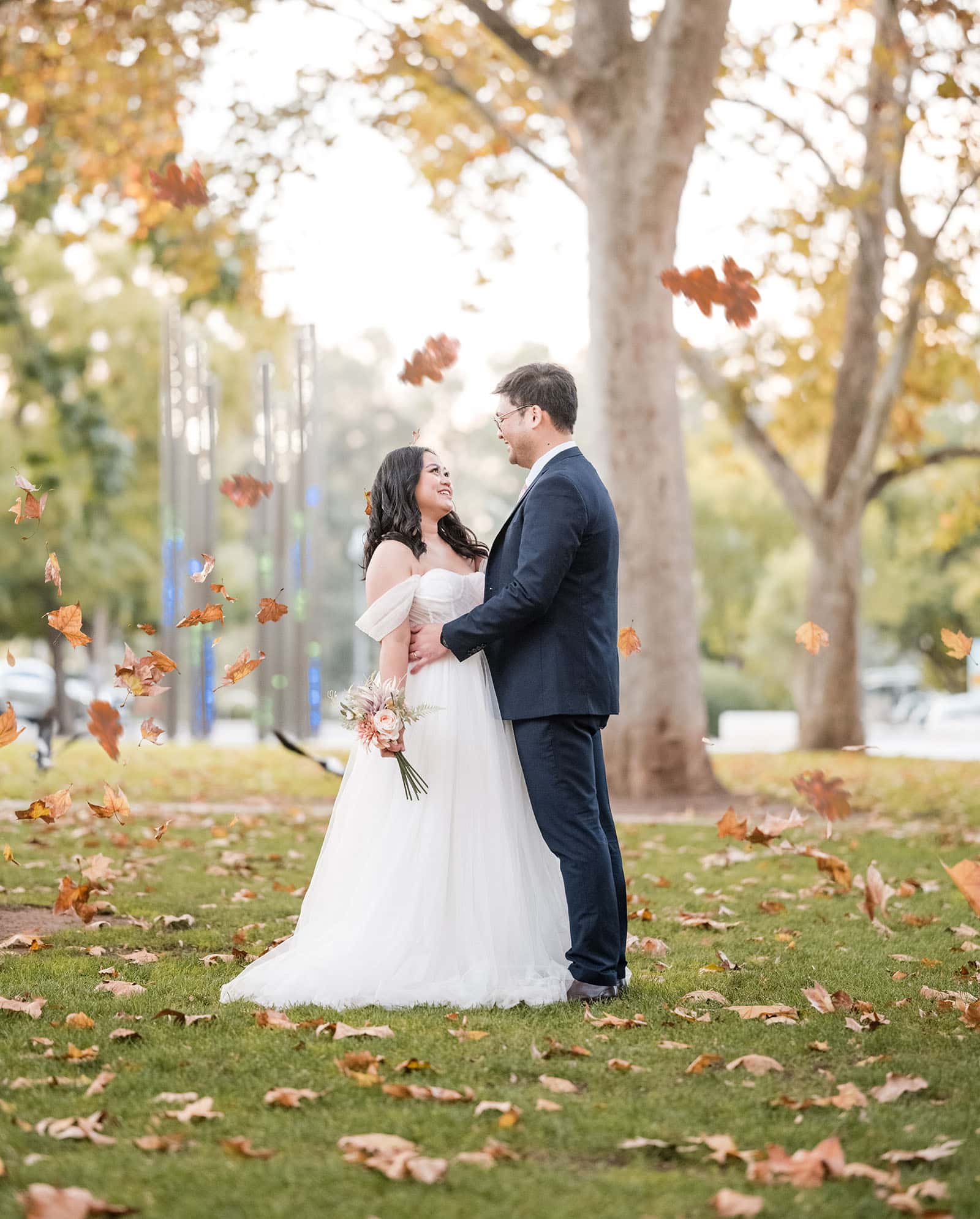 chesser st registration office wedding - khate & angelo 90 bride and groom under falling leaves