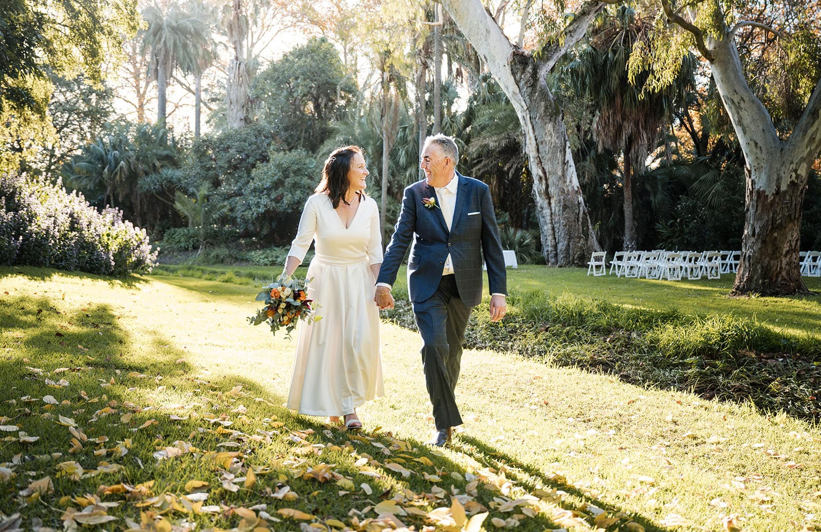 northern palm garden wedding - nicole & daryl 130 Bride and groom walking on grass