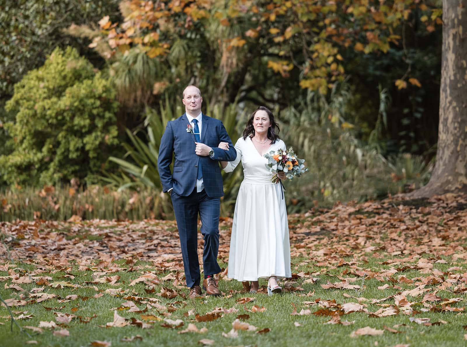 northern palm garden wedding - nicole & daryl 112 Bride approaching backed by autumn colours