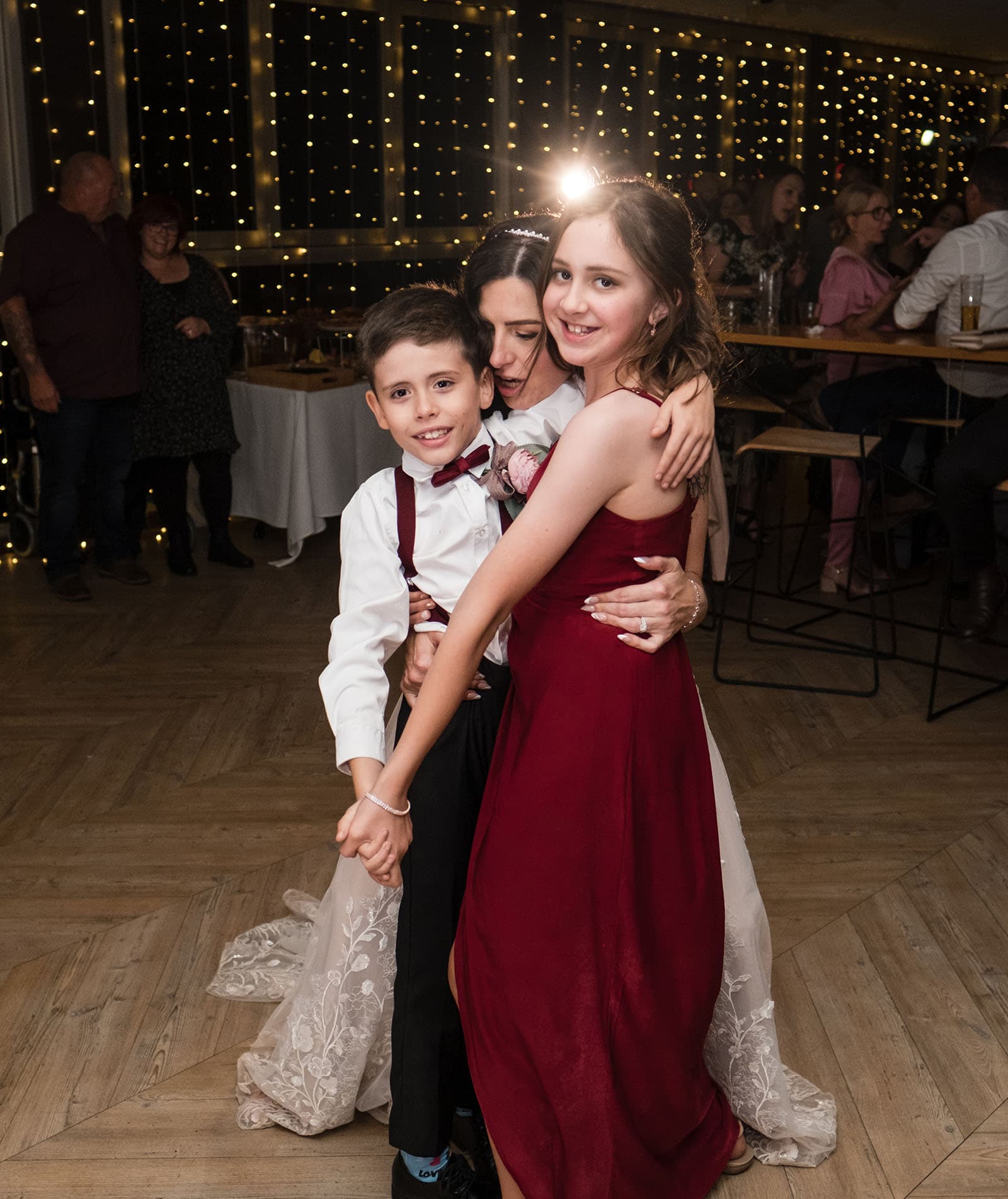 sneakys wedding - ash & michael 126 Bride hugging kids
