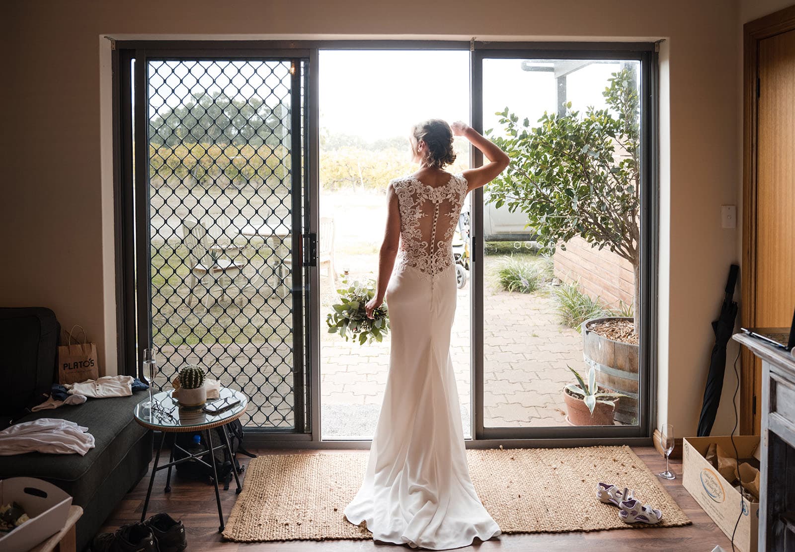 vine shed wedding - kat & katie 208 Bride leaning on sliding door