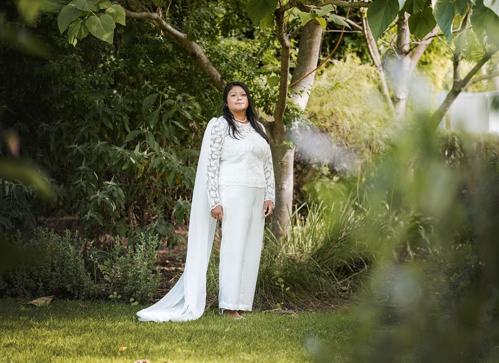 vine shed wedding - kat & katie 196 bride standing alone in garden