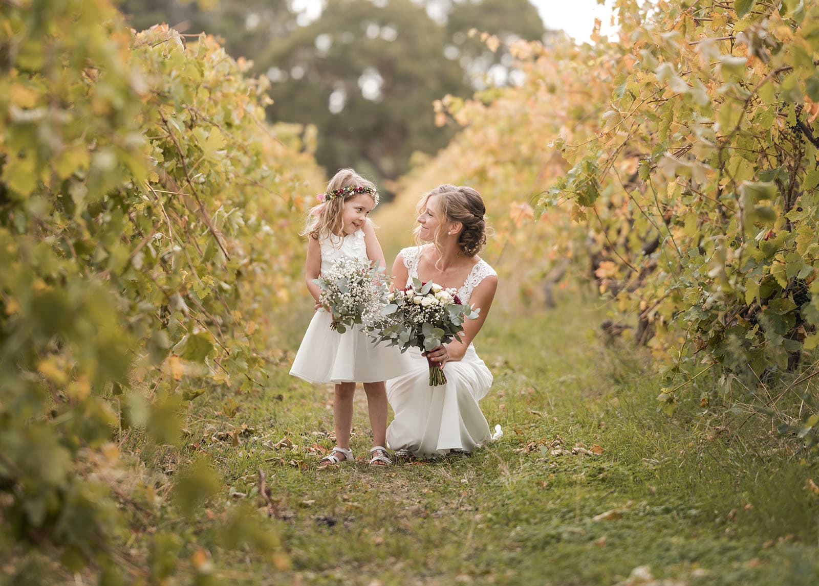 vine shed wedding - kat & katie 212 bride with flower girl in vineyard