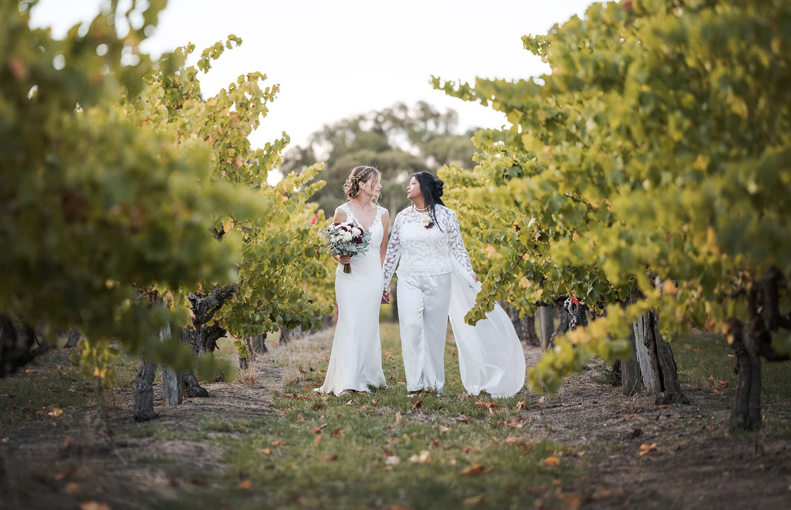 vine shed wedding - kat & katie 238 Brides walking together in vineyard