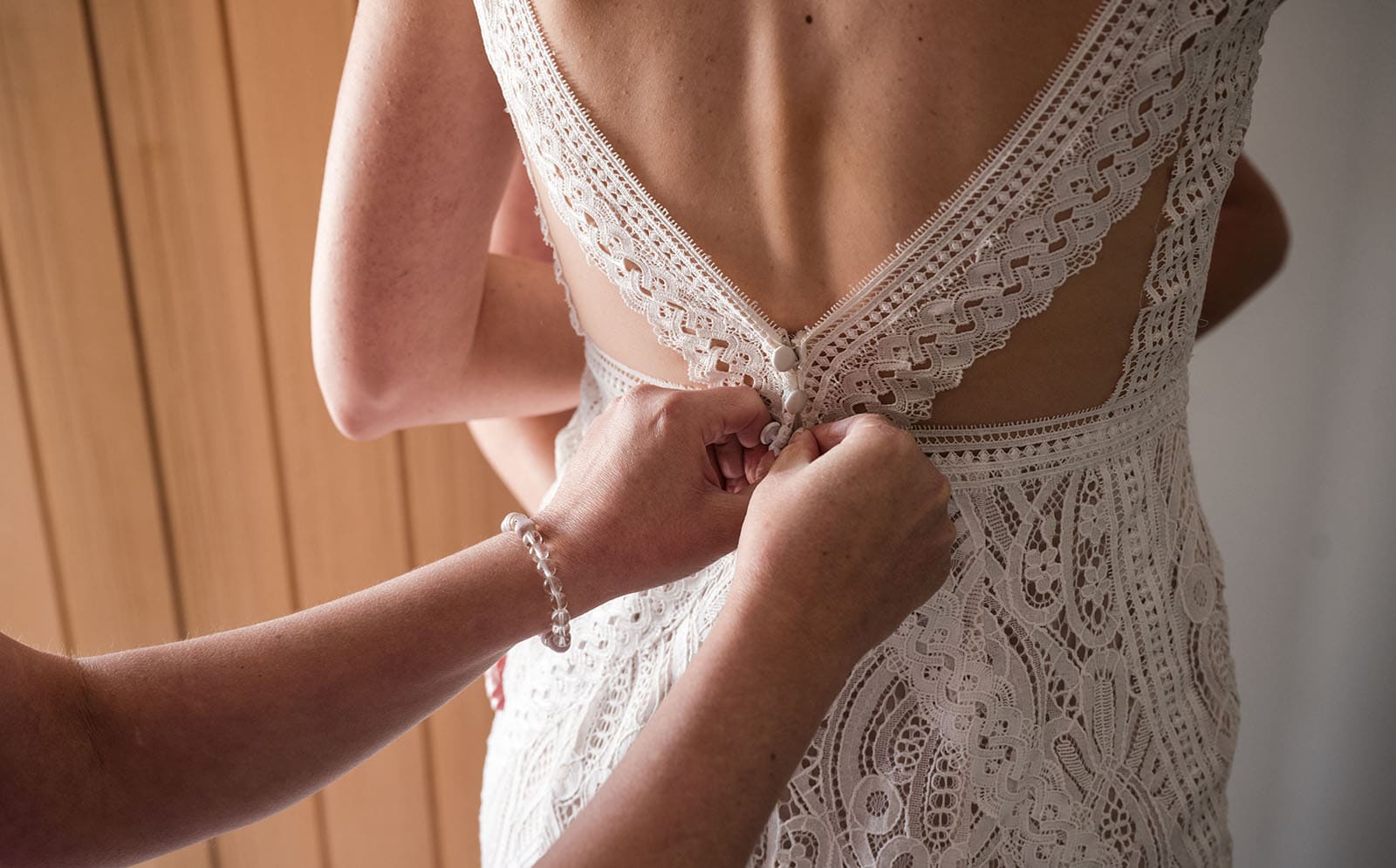 white hill estate wedding - catherine & sean 279 Buttoning up back of wedding dress