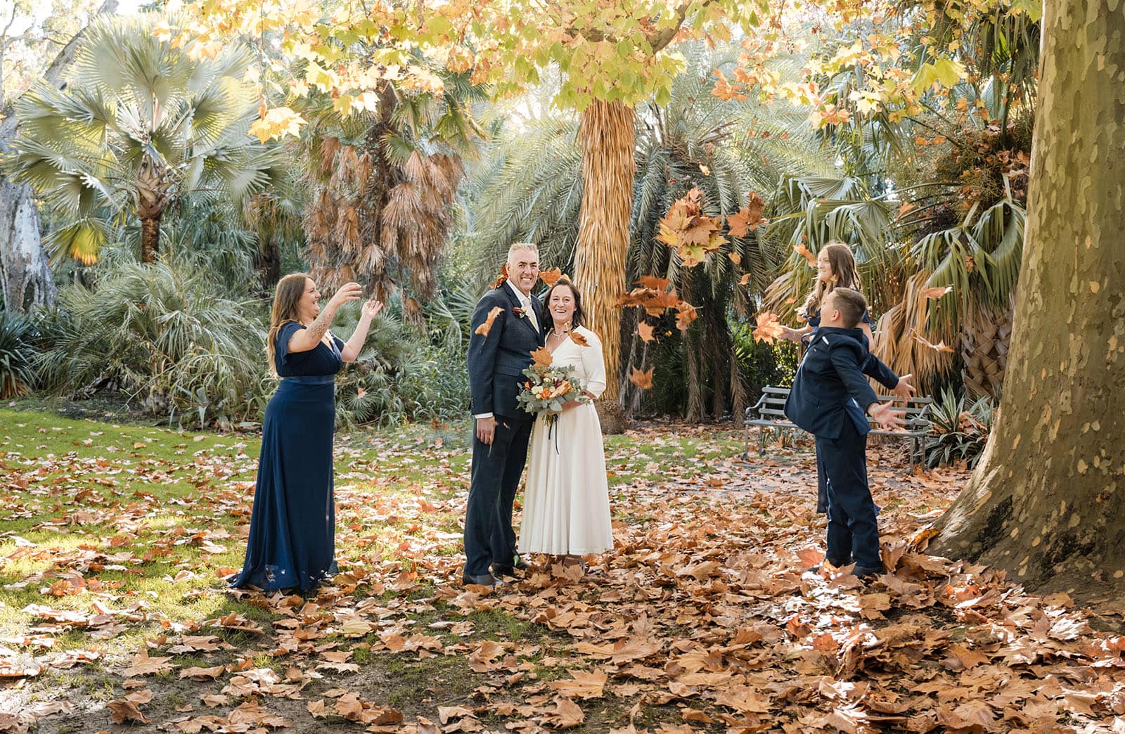 northern palm garden wedding - nicole & daryl 125 Children throwing leaves over bridal couple