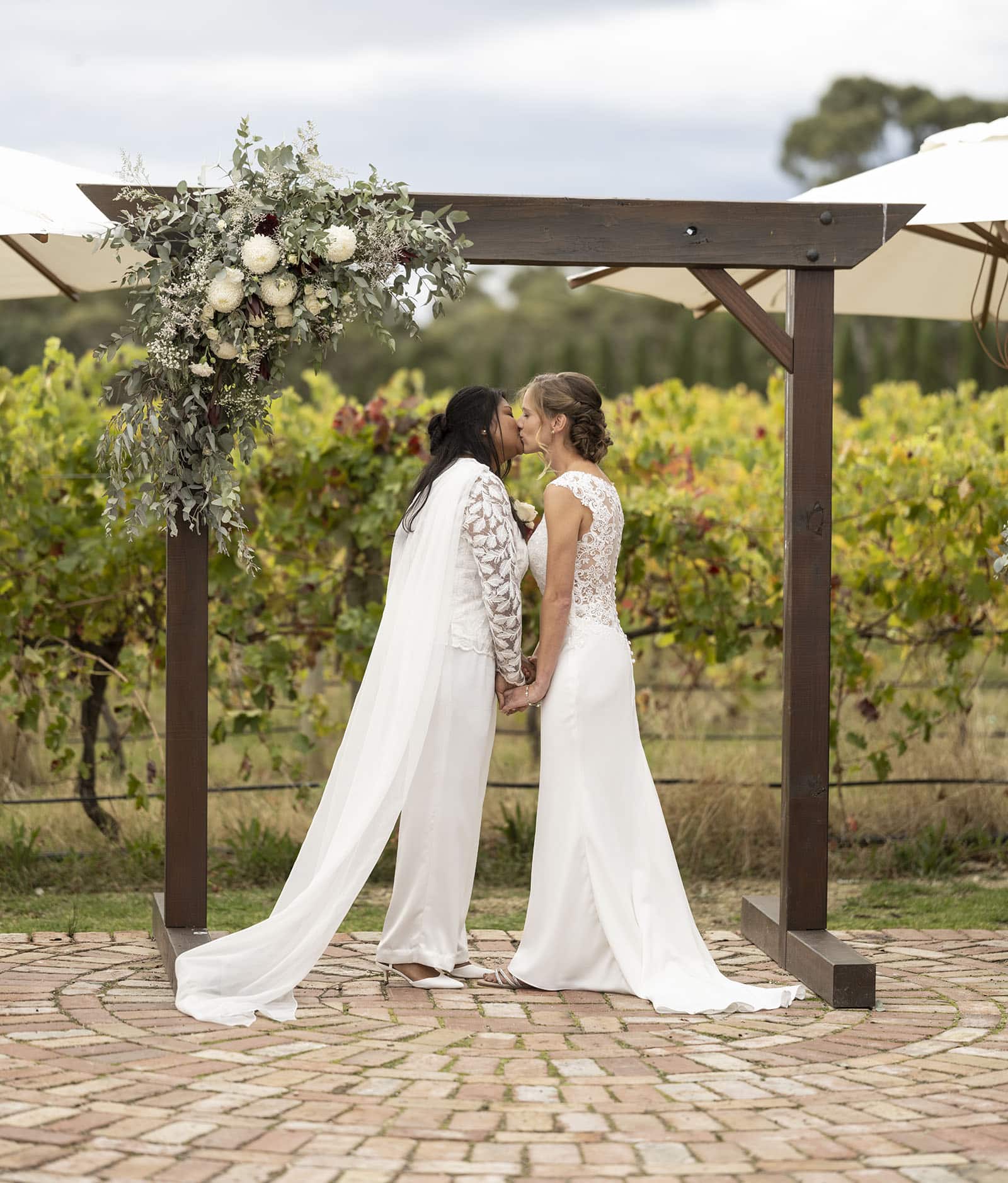 vine shed wedding - kat & katie 227 First kiss under arbour at Vine Shed wedding