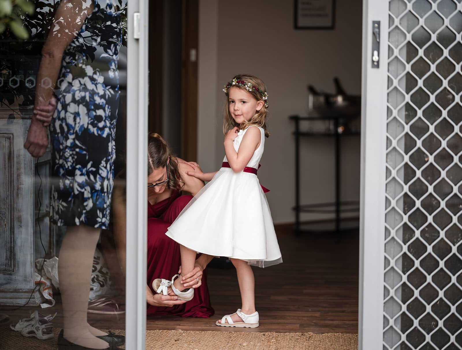 vine shed wedding - kat & katie 206 Flower girl having shoes put on