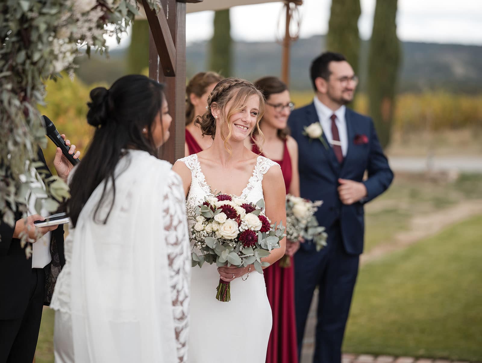 vine shed wedding - kat & katie 221 Grinning bride during cermeony looking at guests