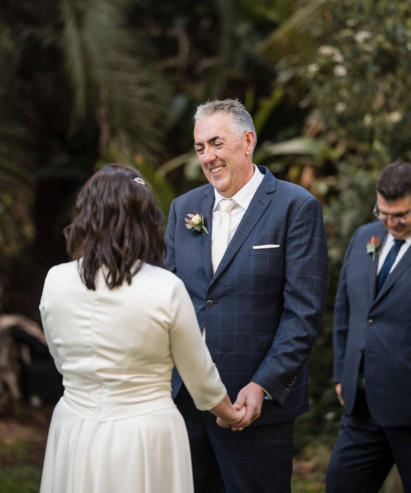 northern palm garden wedding - nicole & daryl 119 Groom grinning at his bride at ceremony