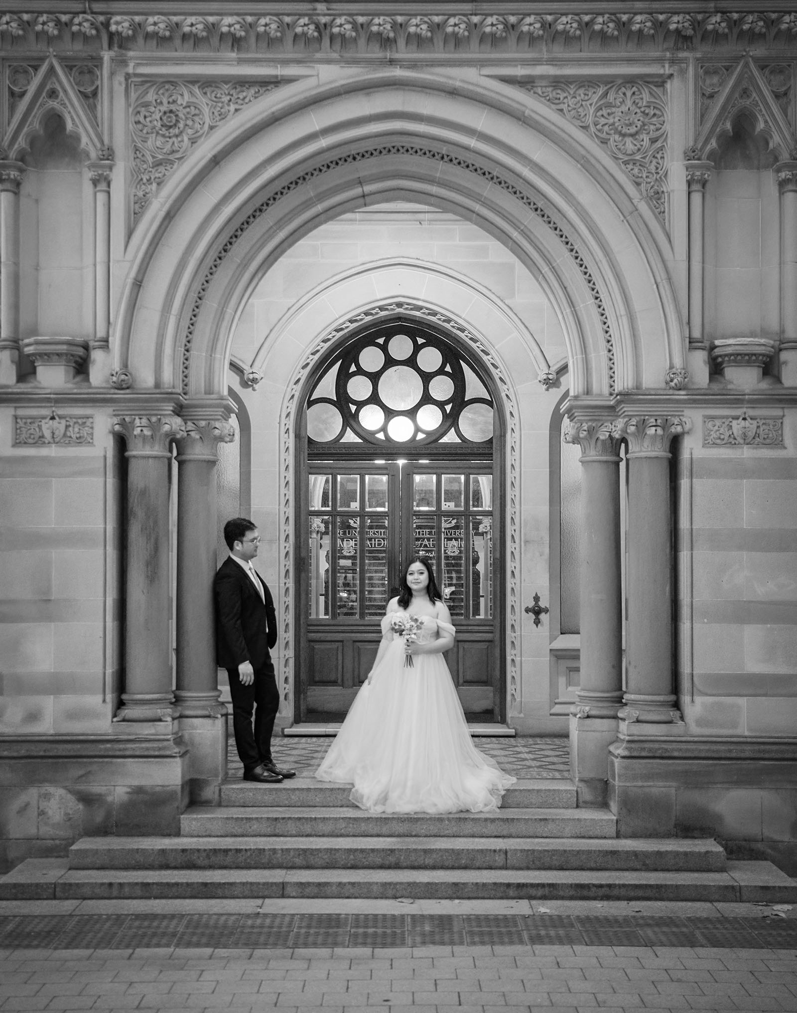 chesser st registration office wedding - khate & angelo 100 groom leaning on arch looking at bride