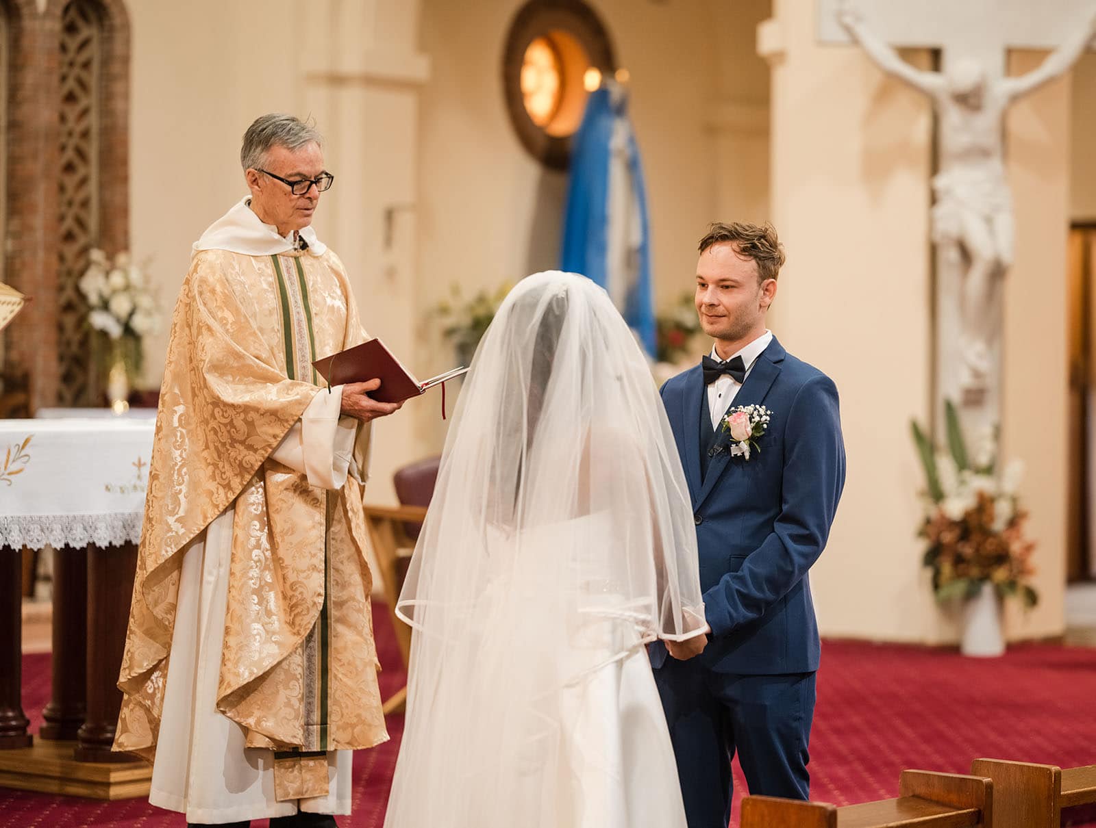 our lady of the rosary church wedding - lorraine & wayne 159 Groom looking at his bride as priest talks