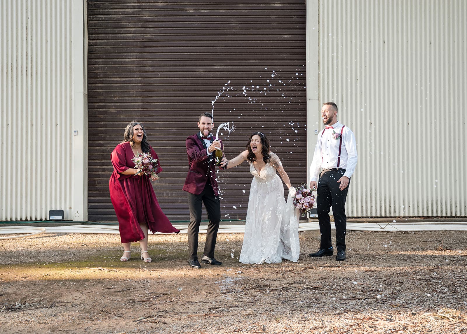 sneakys wedding - ash & michael 90 Groom spraying champagne