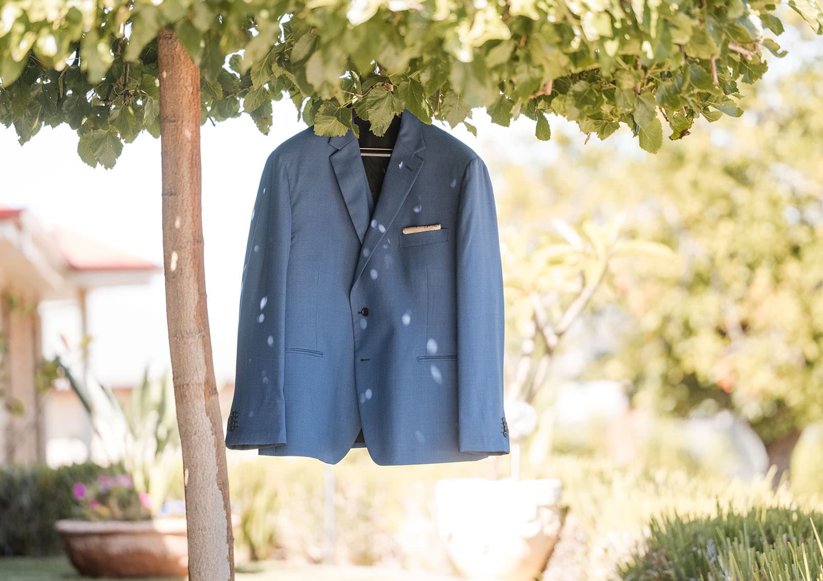 white hill estate wedding - catherine & sean 266 Grooms jacket hanging in tree
