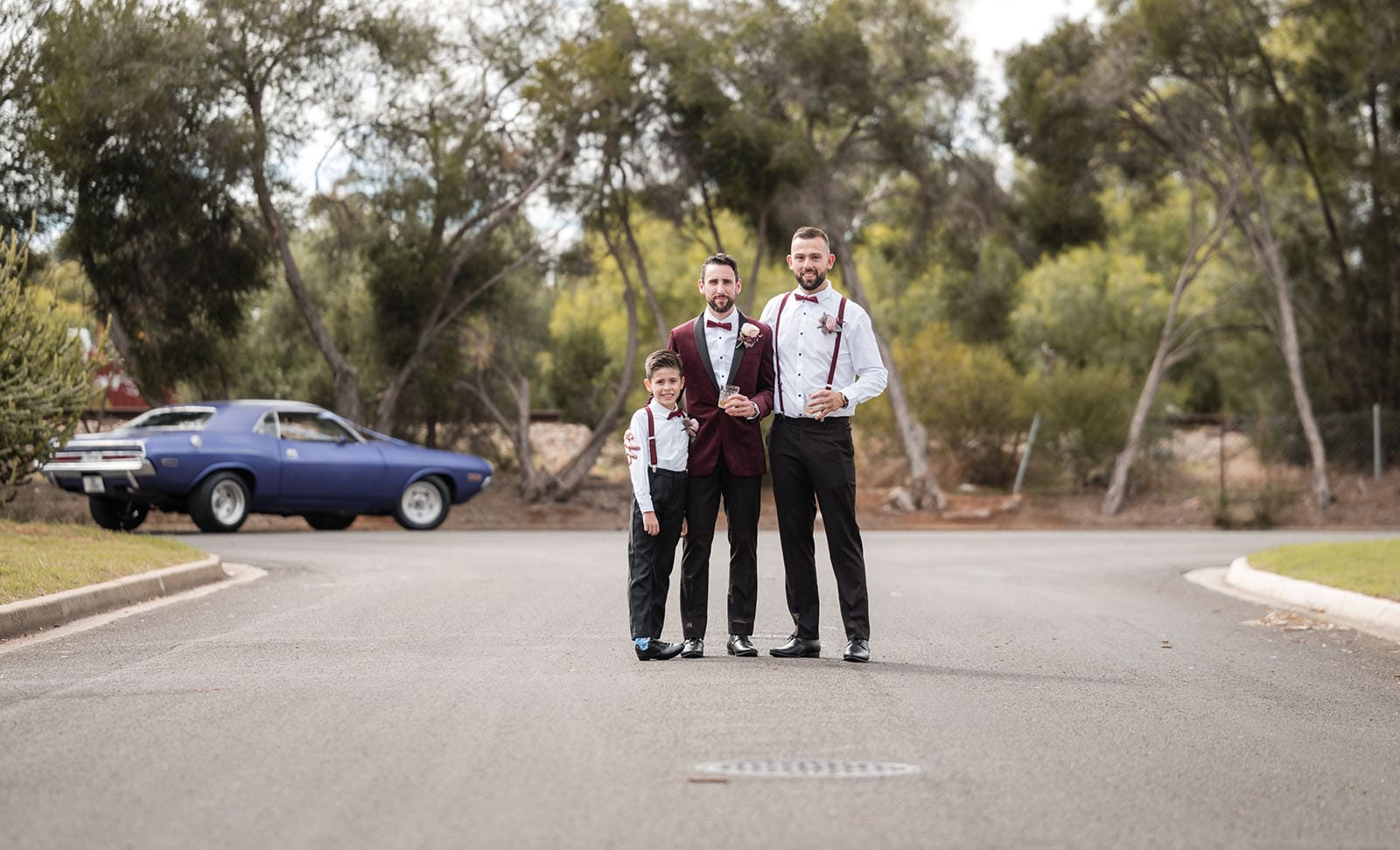 sneakys wedding - ash & michael 54 Groomsmen on road with car
