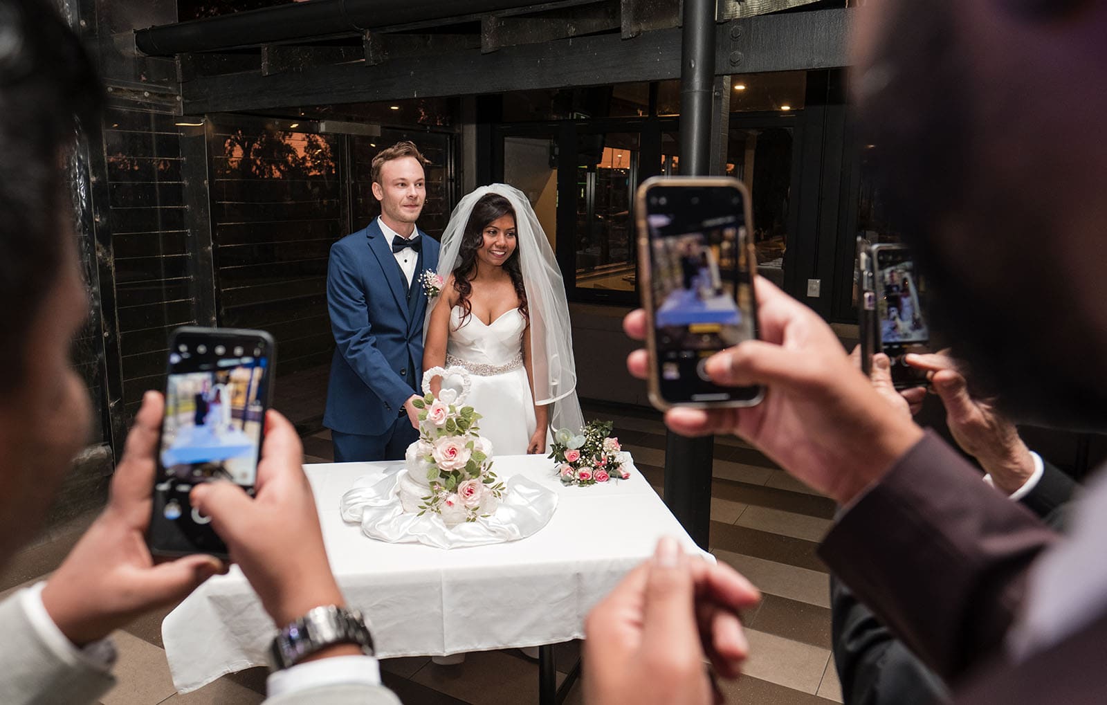 our lady of the rosary church wedding - lorraine & wayne 194 Guests taking photos of bridal couple cutting cake