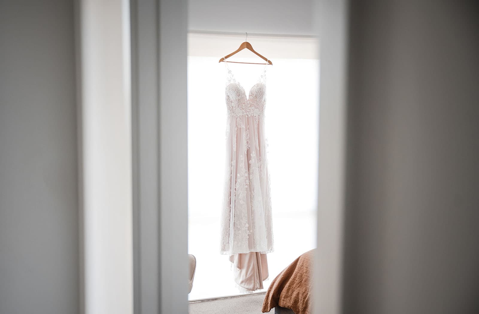 sneakys wedding - ash & michael 58 Hanging wedding dress through door