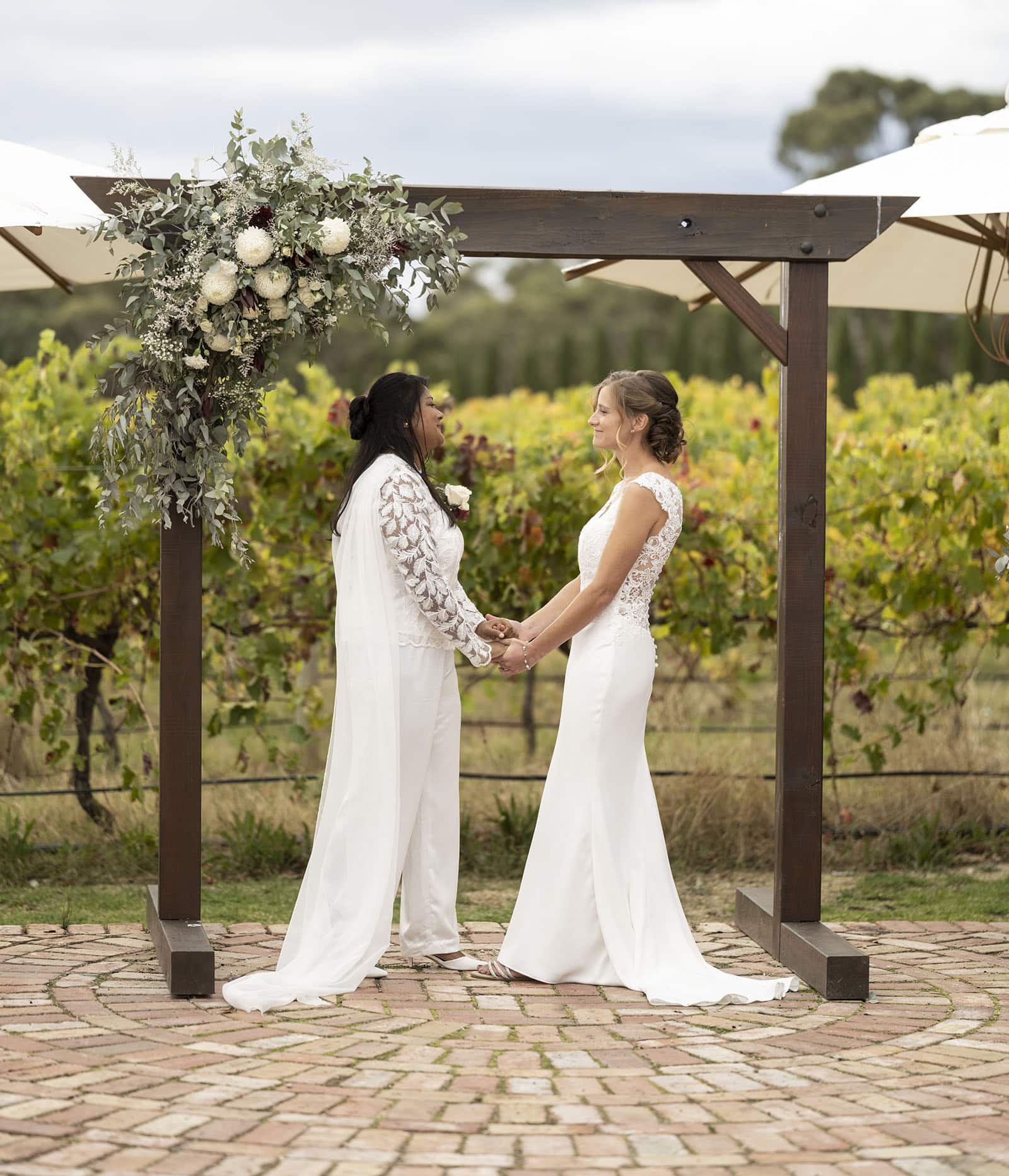vine shed wedding - kat & katie 228 Holding hands under arbour