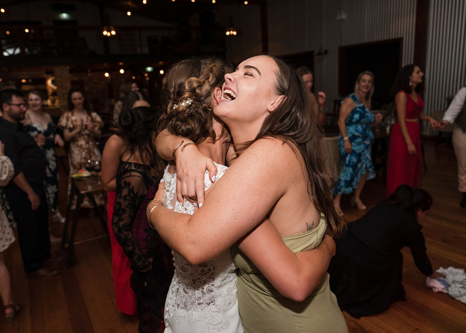 vine shed wedding - kat & katie 263 Laughing guest hugs