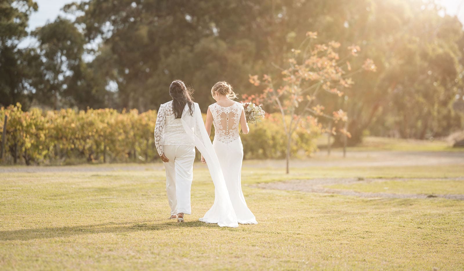 vine shed wedding - kat & katie 233 Married couple walking towards sun