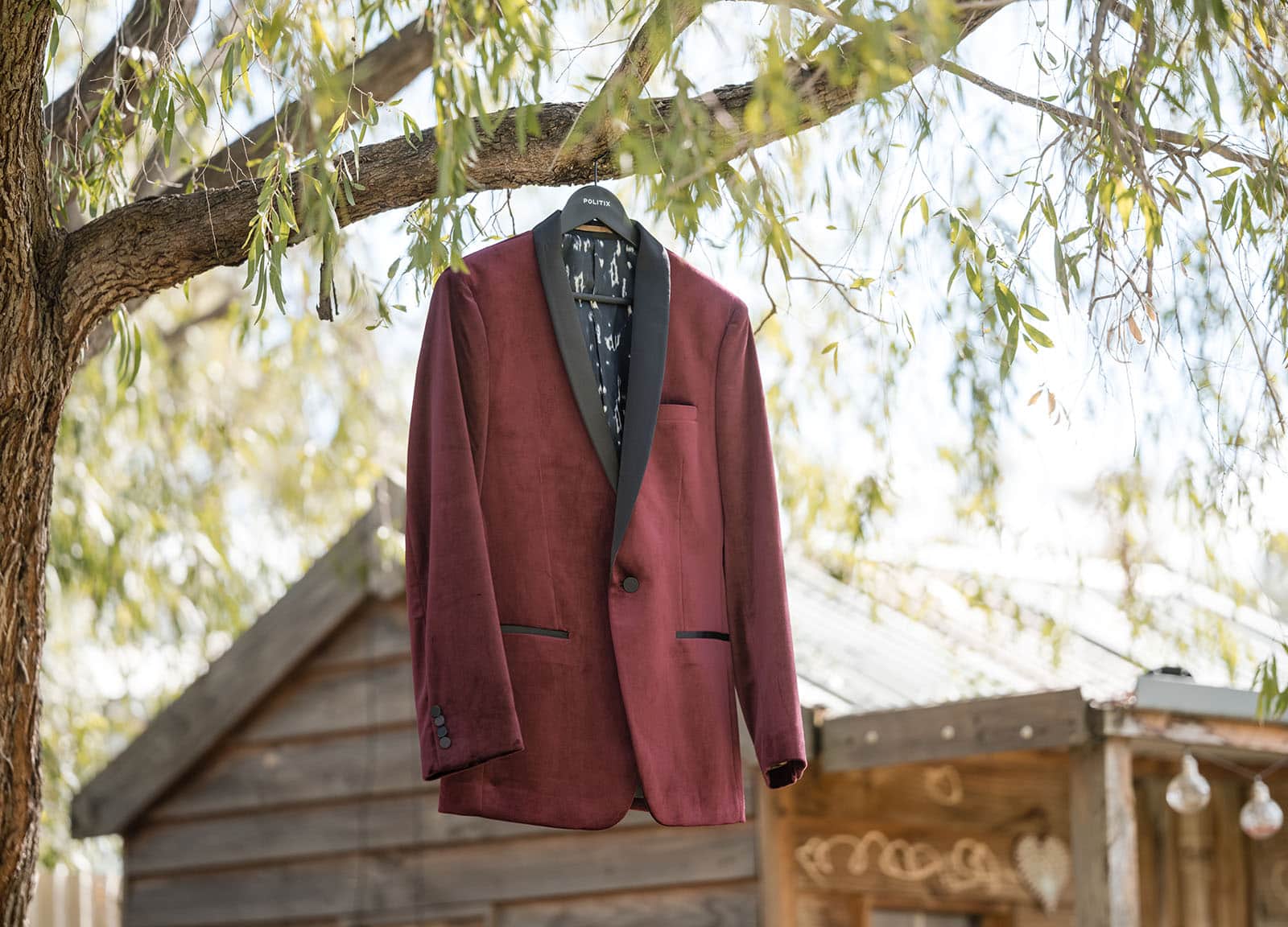 sneakys wedding - ash & michael 40 Red jacket hanging in tree