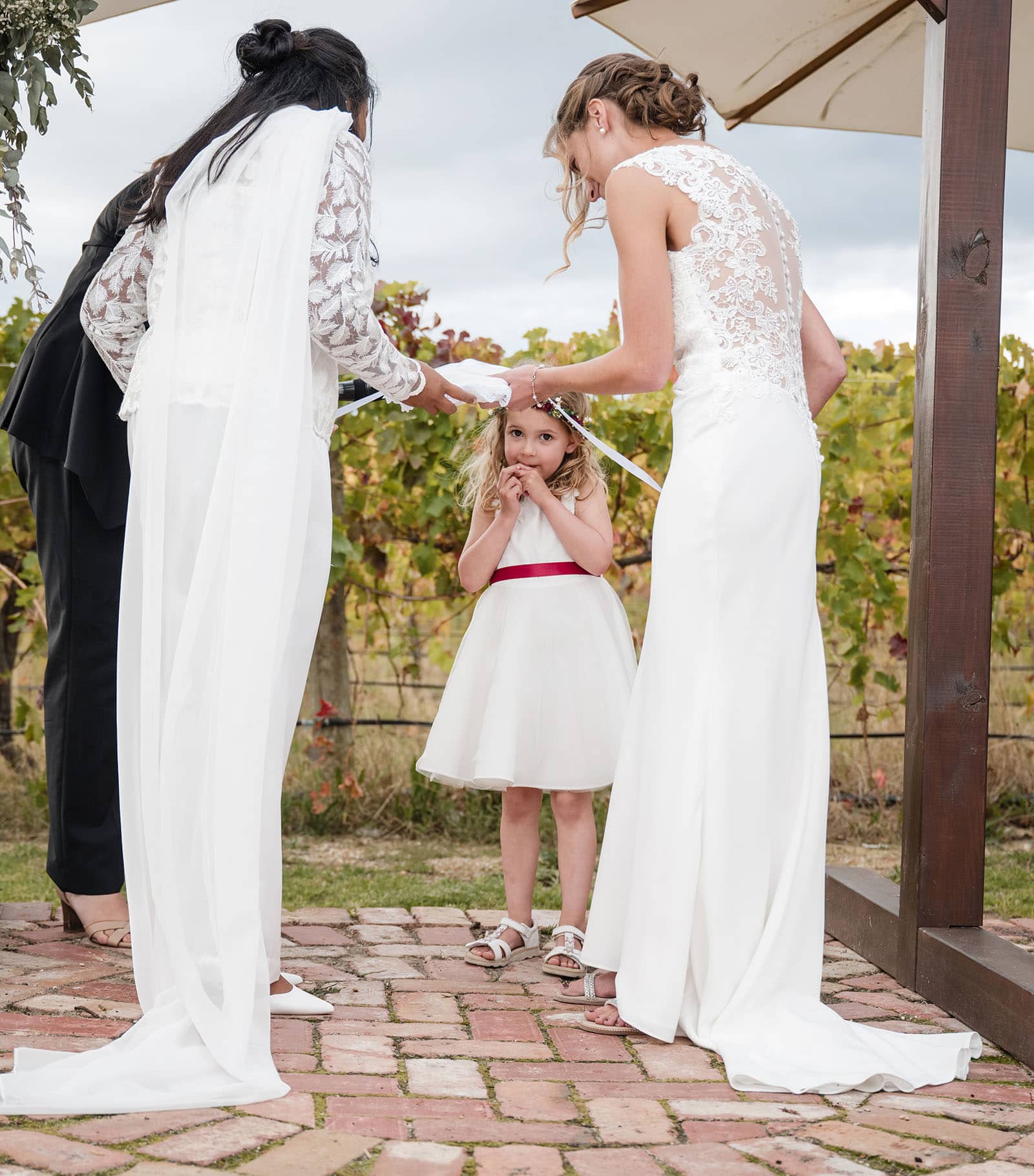 vine shed wedding - kat & katie 224 Shy flower girl during ceremony