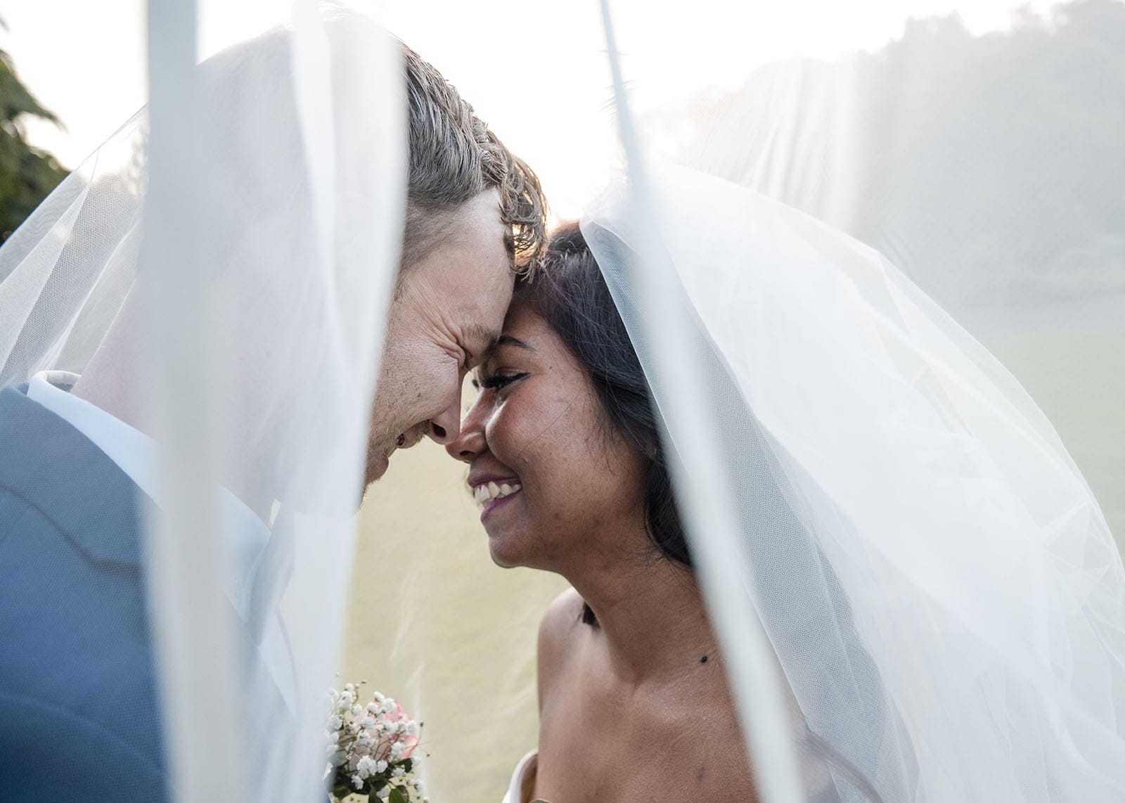 our lady of the rosary church wedding - lorraine & wayne 190 Smiling bridal couple under veil