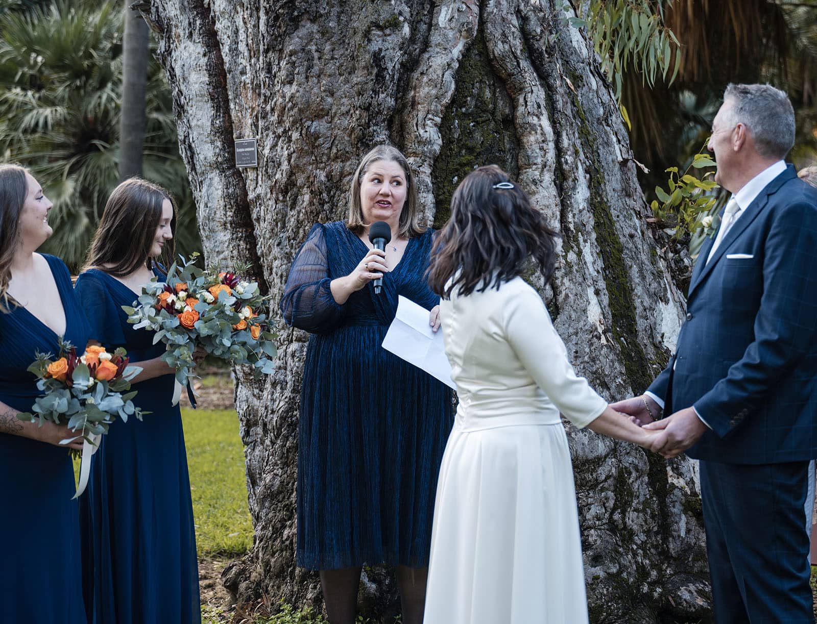 northern palm garden wedding - nicole & daryl 114 Speech giver during ceremony under tree