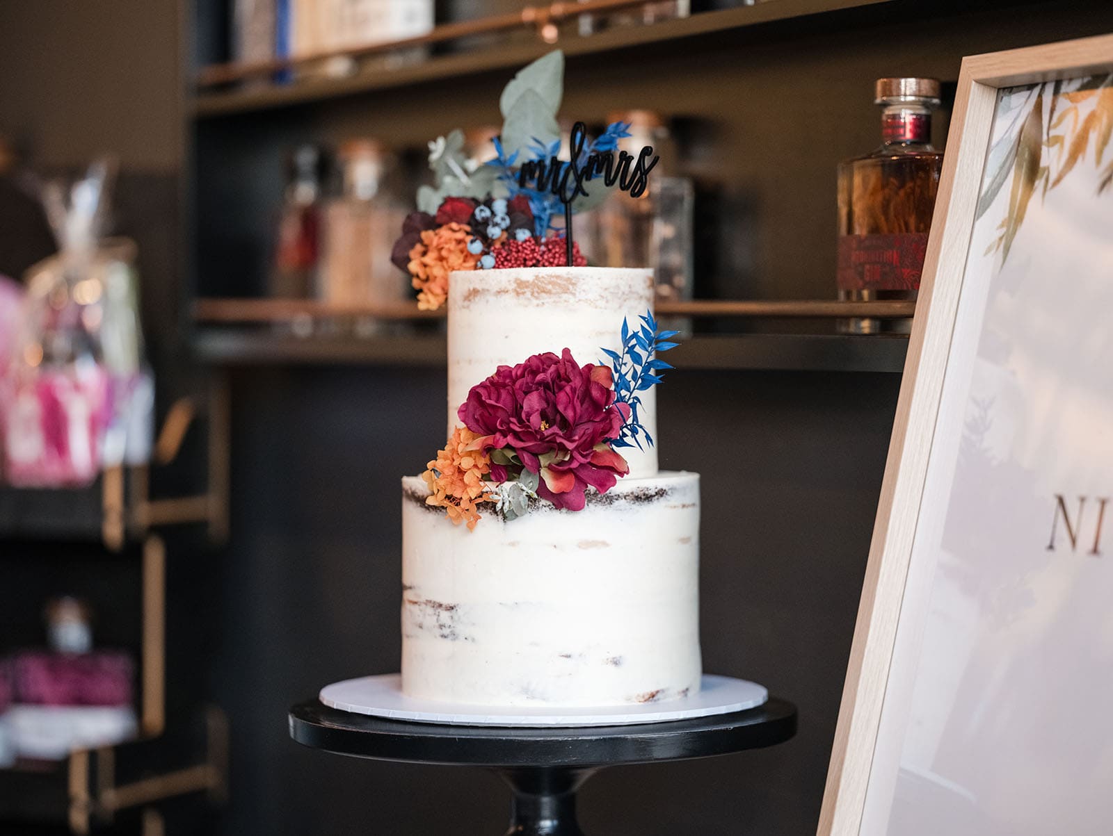 northern palm garden wedding - nicole & daryl 139 Two tiered wedding cake with big red flower