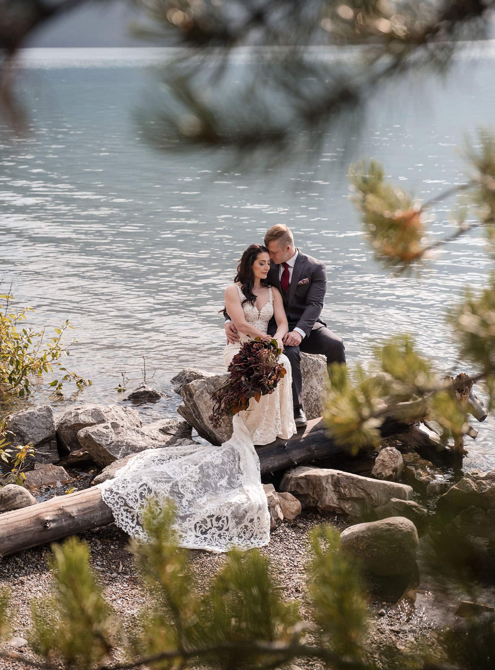 canada's lake louise wedding photoshoot - melodie & brandon 7 Wedding couple through tree