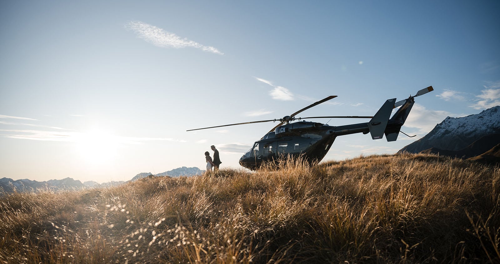 incredible queenstown wedding photoshoot - wendy & frank 46 bride and groom in front of black helicopter
