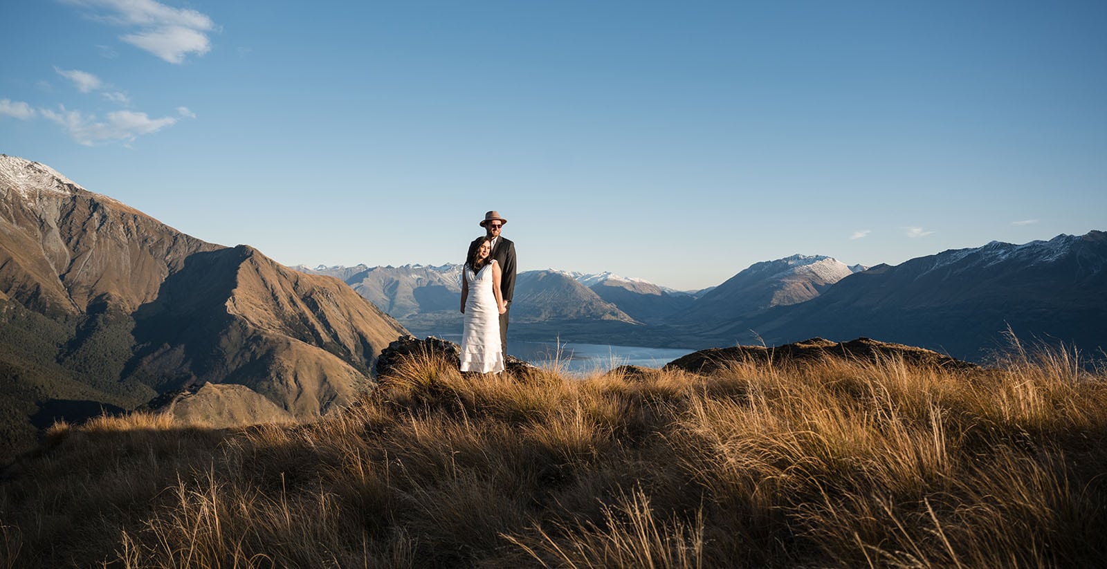 incredible queenstown wedding photoshoot - wendy & frank 40 Bride and groom standing on Crighton peak