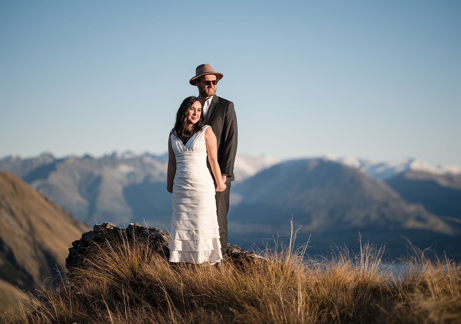 incredible queenstown wedding photoshoot - wendy & frank 57 bride and groom standing together in long grass