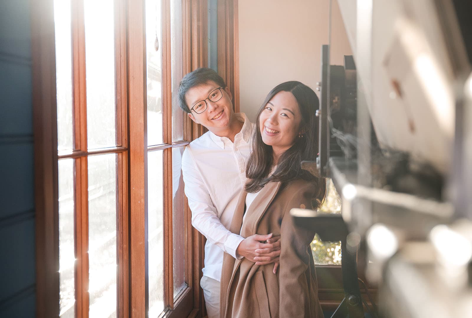 belair train station engagement shoot - melody & chris 111 Couple near window int he control room