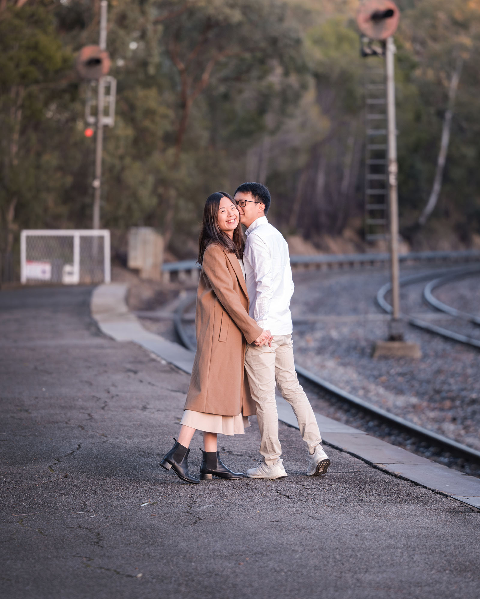 belair train station engagement shoot - melody & chris 83 Couple walking together on rail platform