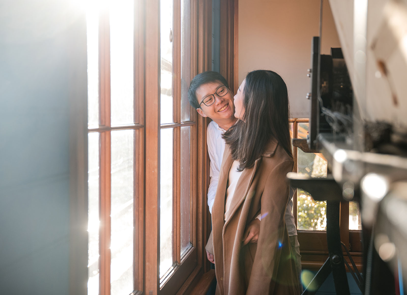 belair train station engagement shoot - melody & chris 110 Sunlight streaming throguh window as couple share a moment