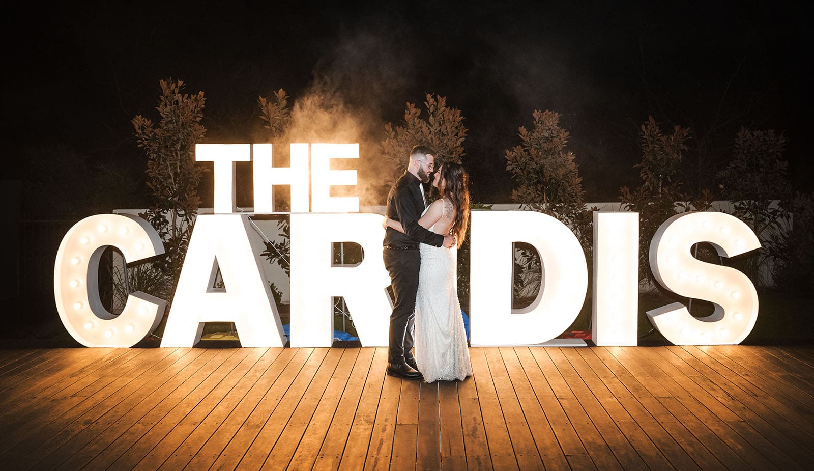 the house on haines wedding - emily & andrew 242 Bride and groom in front of name sign